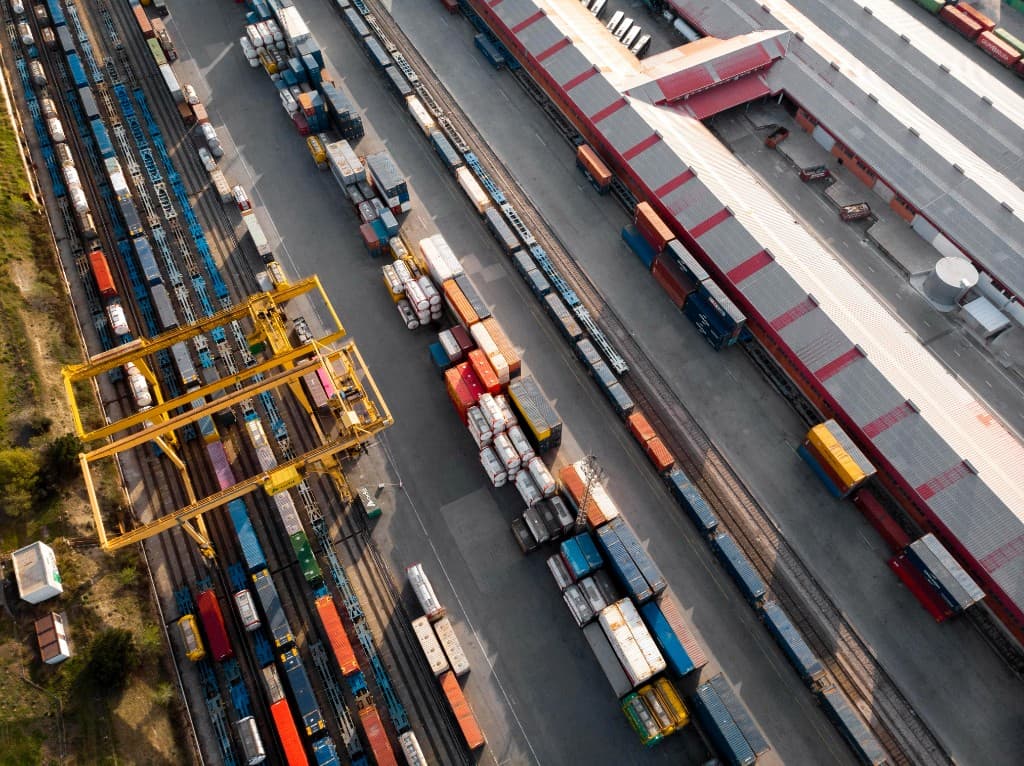 Aerial view of intermodal logistics terminal with containers and crane